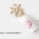 EstroPro瓶子，白色大理石上的药片溢出瓶子